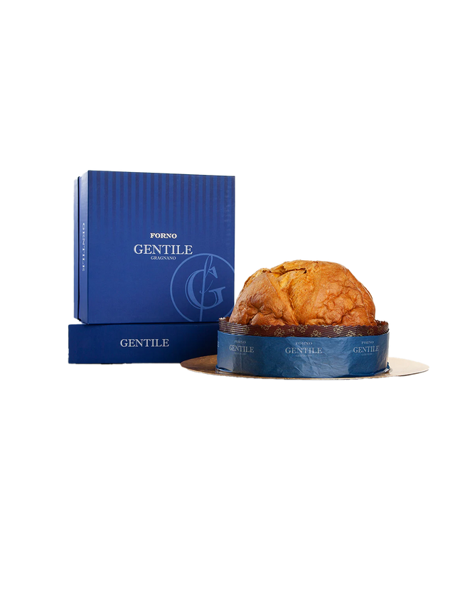A traditional Italian panettone cake with candied fruits visible on the surface, presented next to its blue packaging box with the brand 'Gentile' written on it.
